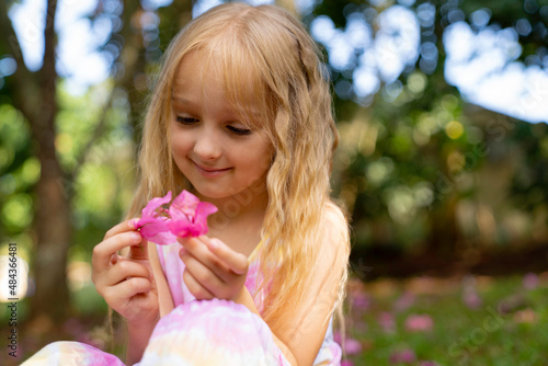 little girl with pink flower