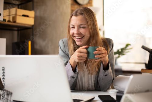 Happy businesswoman working on laptop. Portrait of beautiful businesswoman having video call.