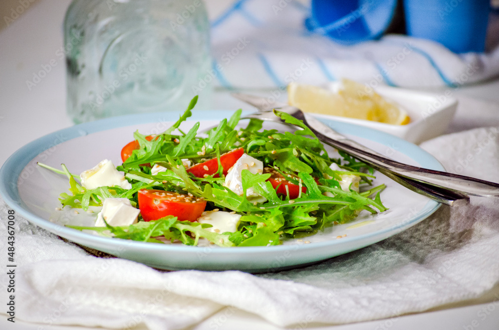 Arugula salad with feta cheese and cherry tomatoes Arugula salad with feta cheese and cherry tomatoes
