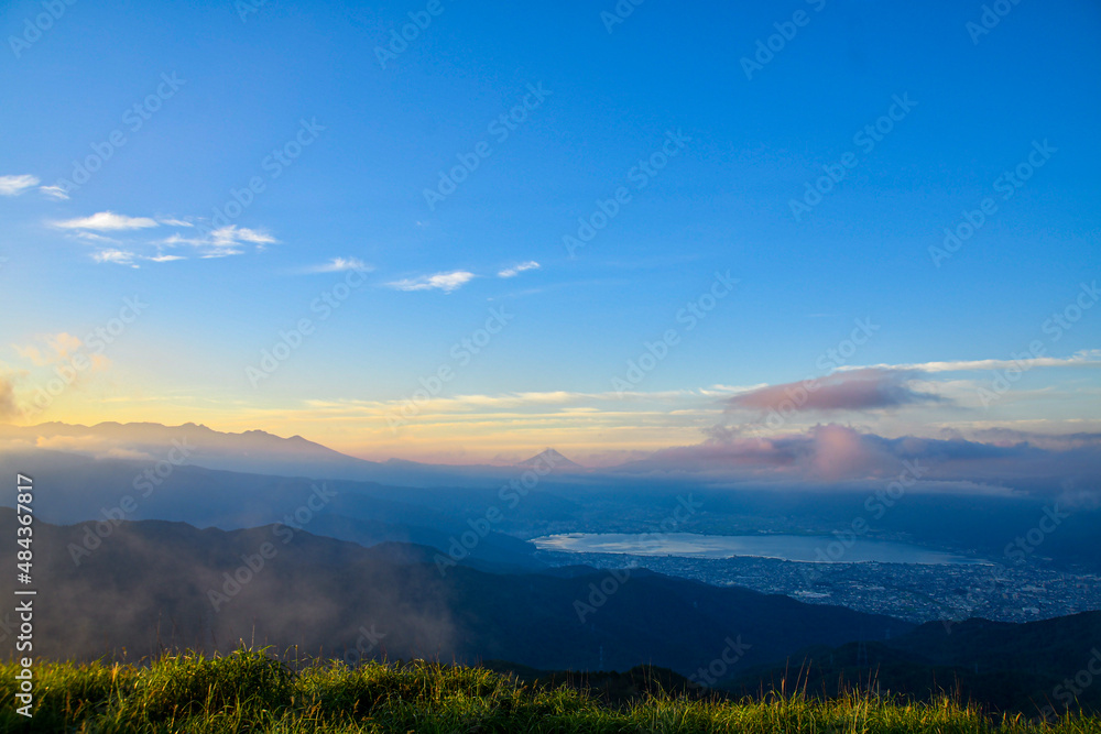 Mt. Fuji sit with Lake Suwako in the hazy and obscure morning light in summer Japan. Mt. Fuji sit with Lake Suwako in the hazy and obscure morning light in summer Japan.