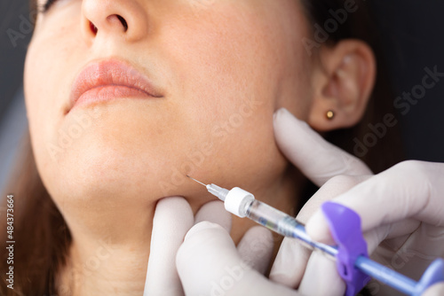Botox injection to the face in the chin area. aesthetics, medicine concept. Botulinum toxin. youth injections. 