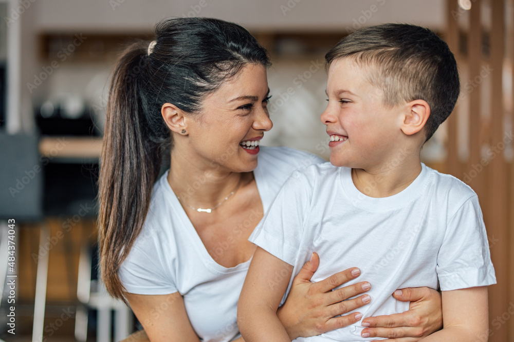Mother's day, smiling caucasian mother, tickling her son, while he laughs. Mother's day, smiling caucasian mother, tickling her son, while he laughs.