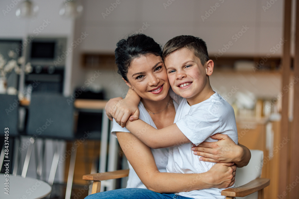Portrait of delighted single mother, making a happy picture with her son, at home. Portrait of delighted single mother, making a happy picture with her son, at home.