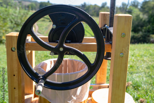 Closeup of an outdoor wooden apple cider press flywheel photo