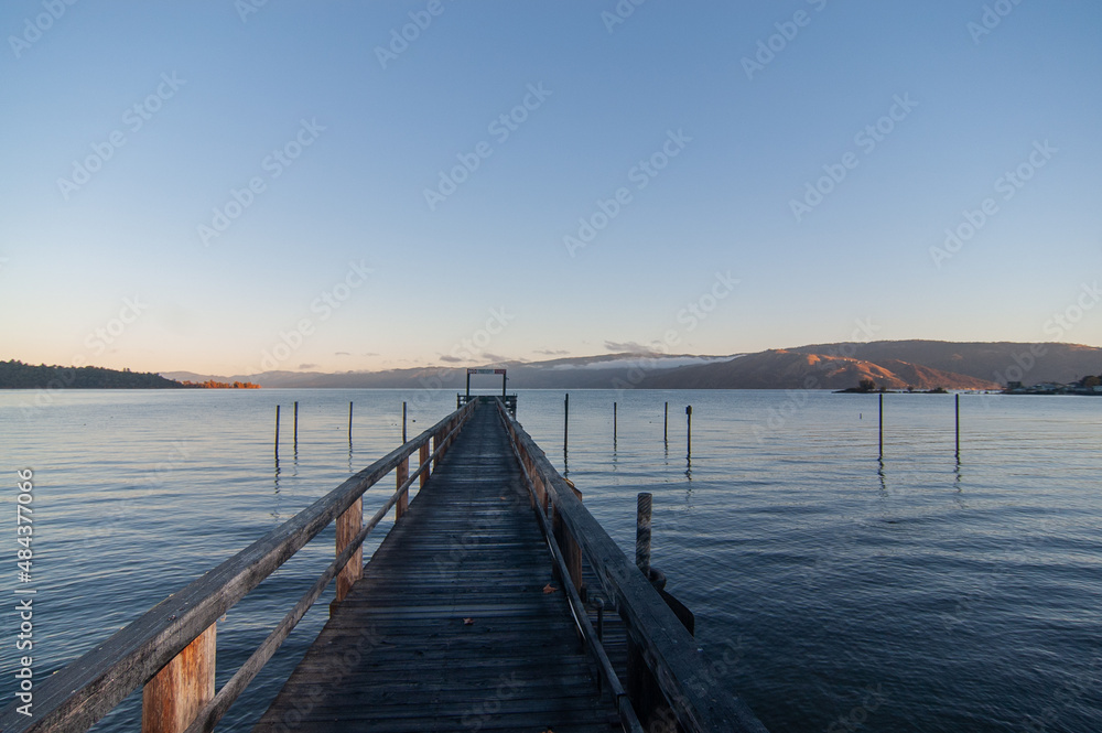 Early morning at the lake on the dock in autumn