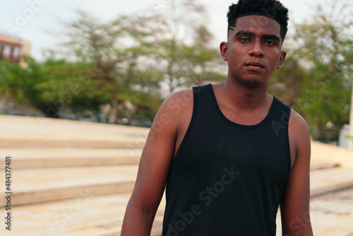 Portrait of African American man standing in city park. © Hector Pertuz