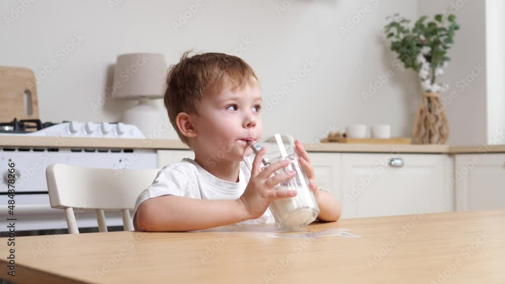 Little boy drinks milk. Happy blue-eyed child has breakfast. Healthy food child having breakfast child dream concept. Little boy drinks milk. Happy blue-eyed child has breakfast. Healthy food child having breakfast child dream concept.