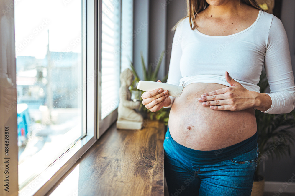 Pregnant Woman Applying Moisturizer Cream On Her Belly Against Stretch Marks Close Up Pregnant 