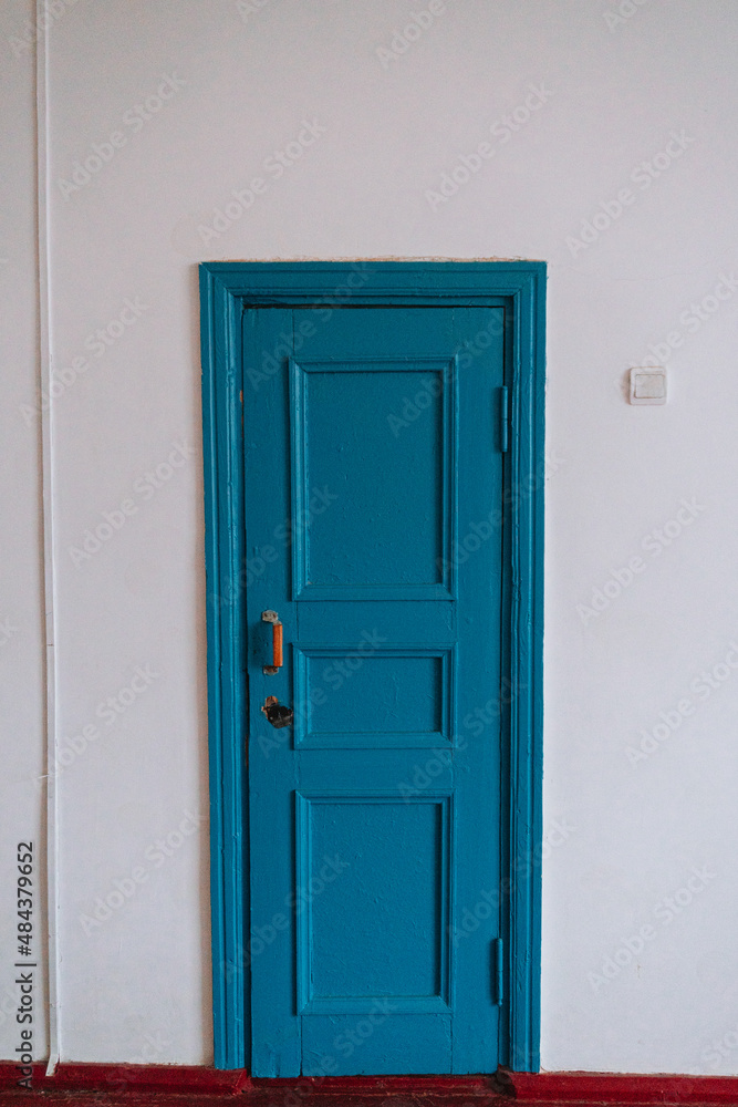 blue door in a white wall