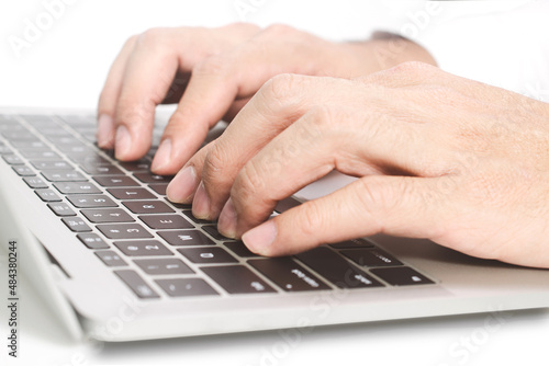Man hands writing on laptop, isolated on white © olando