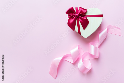 Heart shaped gift box on a pink background with copy space. The concept of a holiday  gifts  congratulations.