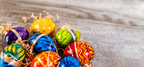 Easter eggs on wooden background with bright tones.