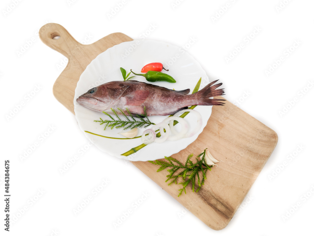 Rooster hind grouper or Pink Grouper decorated on a white plate.Selective focus. Rooster hind grouper or Pink Grouper decorated on a white plate.Selective focus.