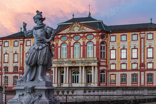 Stature in front of Bruchsal castle after sunset at blue hour. Dramatic sky. photo