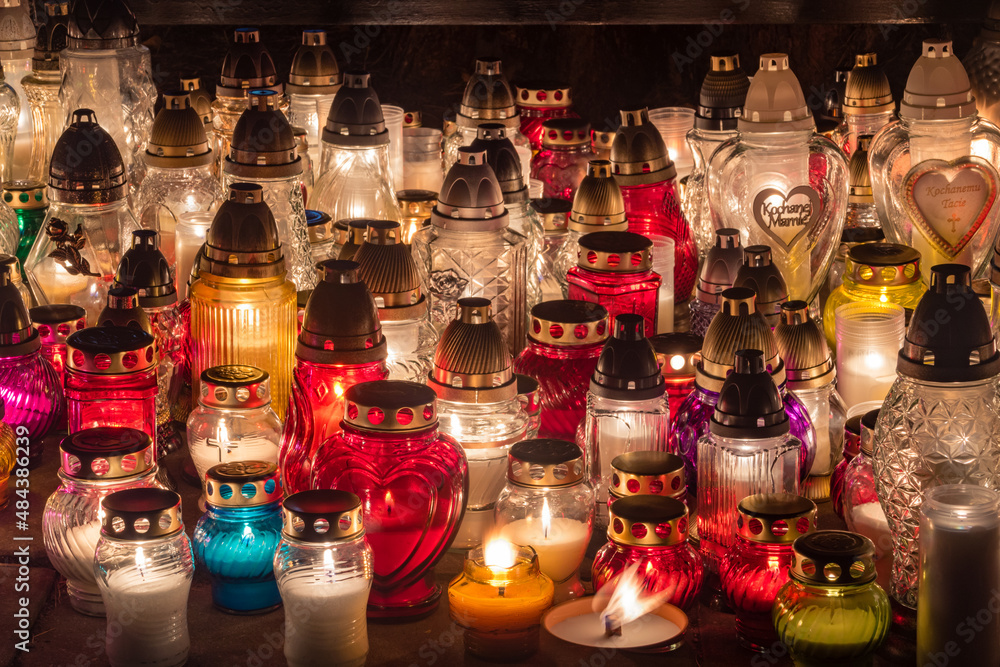 Colorful candles are burning on Polish cemetery during All Saints Day at night. Colorful candles are burning on Polish cemetery during All Saints Day at night.