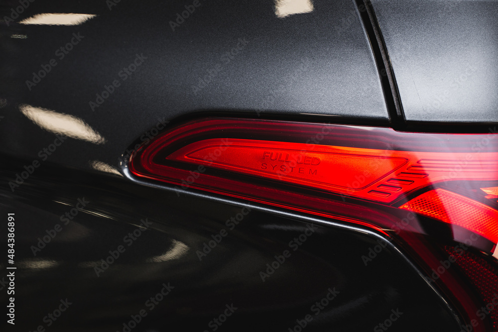 Detail on the rear light of a black car