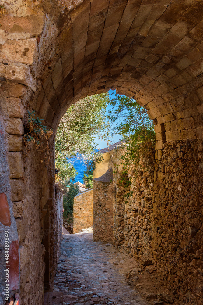 Naklejka premium View of traditional architecture and yellow stone's arch from the medieval castle of Monemvasia, Lakonia, Peloponnese.