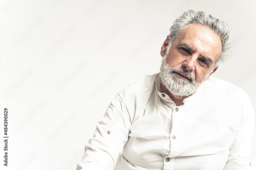 Stylish middle-aged man in white shirt posing on white background. High quality photo Stylish middle-aged man in white shirt posing on white background. High quality photo