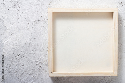 Wooden frame, box on a concrete wall Abstract background