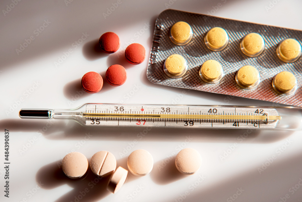 Abstract image of a thermometer with high temperature and medication (Сovid - concept).