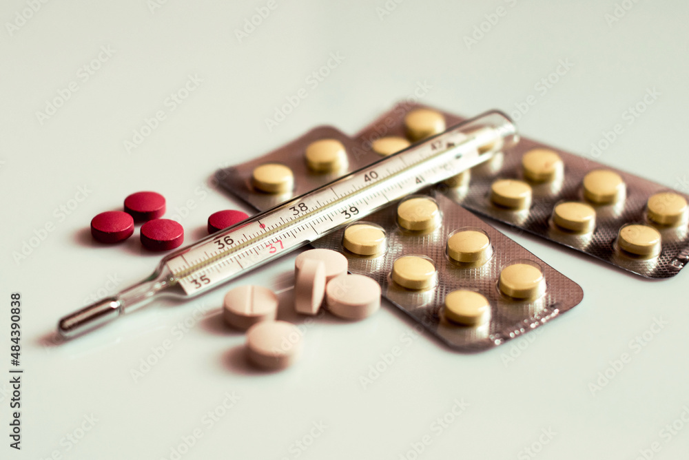 Abstract image of a thermometer with high temperature and medication (Сovid - concept).