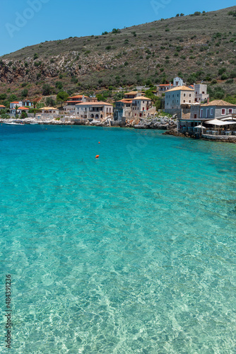 view of Limeni village with the turquoise waters and the stone buildings as a background in Mani, South Peloponnese , Greece.
