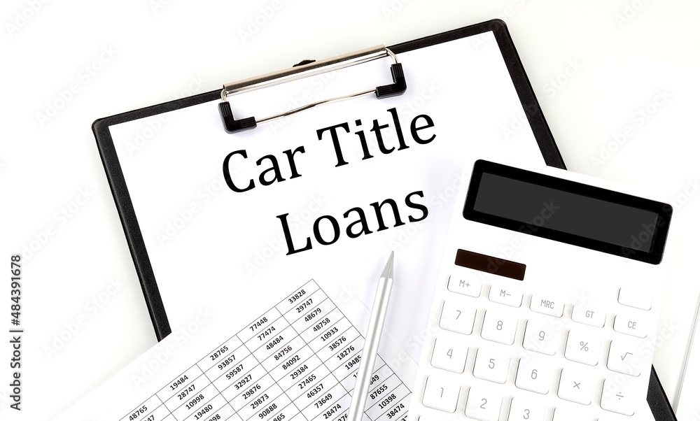CAR TITLE LOANS text on folder with chart and calculator on white background CAR TITLE LOANS text on folder with chart and calculator on white background