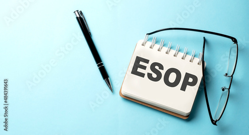 ESOP text written on a notepad on the blue background photo