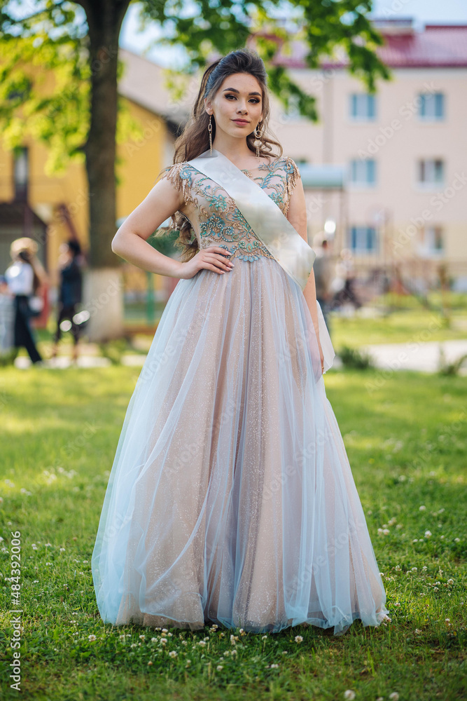 Beautiful schoolgirl in dress at the prom at school. Beautiful schoolgirl in dress at the prom at school.