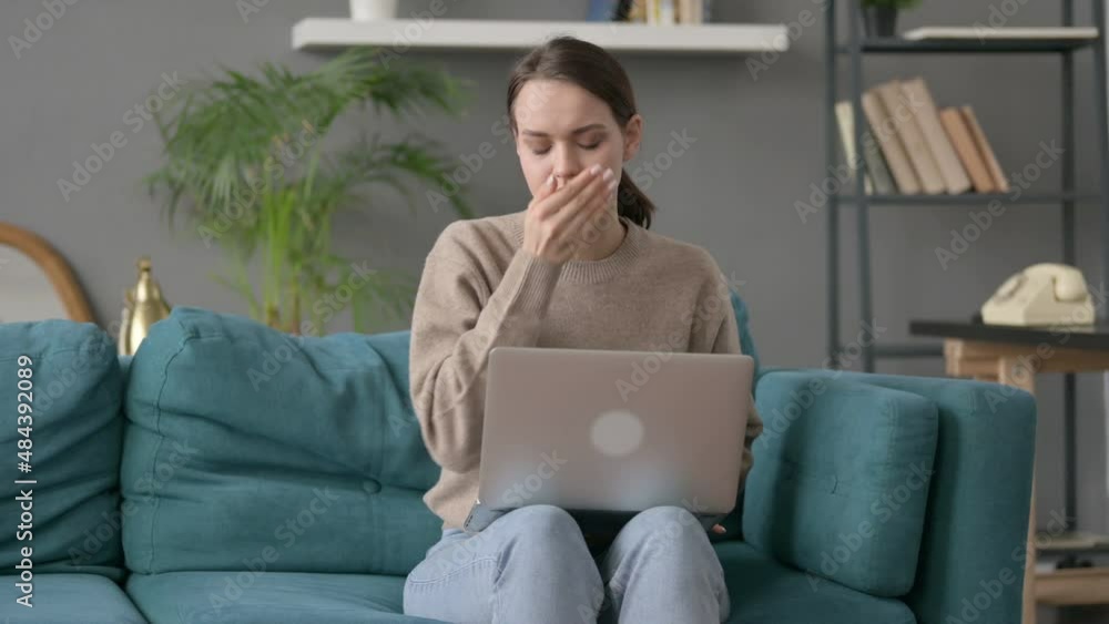 Woman with Laptop Coughing on Sofa 