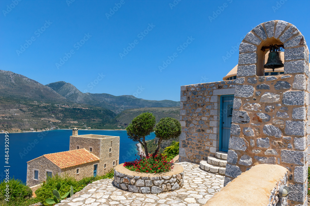 view of  Limeni village with fishing boats in  turquoise waters and the stone buildings as a background  in Mani, South Peloponnese , Greece.