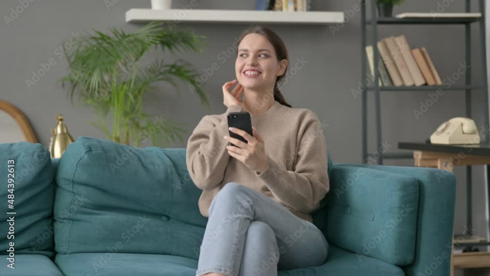 Woman having Success on Smartphone at home Woman having Success on Smartphone at home