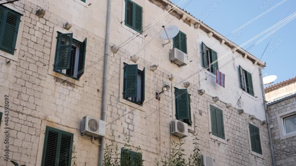 House with green window blinds and clothesline. House with green window blinds and clothesline.