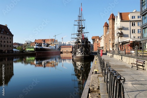 Panorama of Old Town and new buildings on Olowianka island in Gdansk. Motlawa canal with ships. Beautiful reflections in water. Poland photo