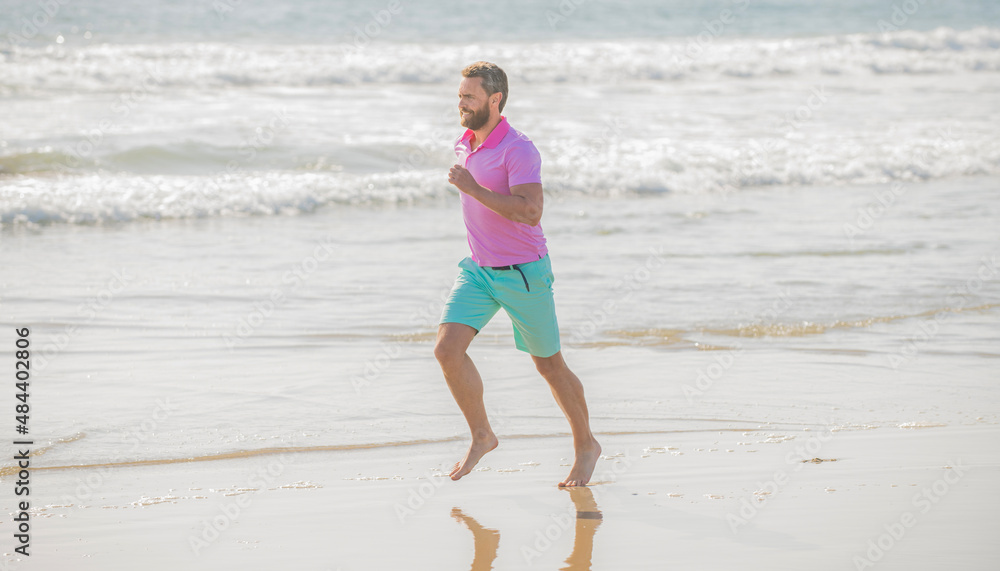 mature athletic man running on summer beach for training, achievement mature athletic man running on summer beach for training, achievement