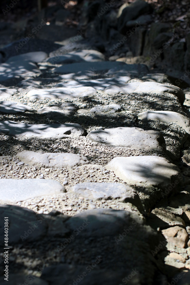 Rocky stone pavement and gutter in the heart of mountain to reach the shrine. Photograph taken on a sunny winter day with high contrast shadows, Rocky stone pavement and gutter in the heart of mountain to reach the shrine. Photograph taken on a sunny winter day with high contrast shadows,