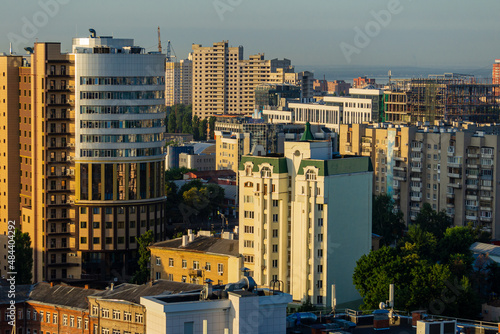 Voronezh, Russia, June 18, 2019: View from the window of skyscraper on city. Modern high-rise buildings against blue sky. Close-up of round building.
