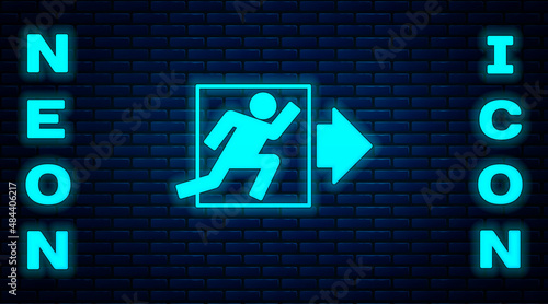 Glowing neon Fire exit icon isolated on brick wall background. Fire emergency icon. Vector