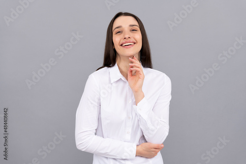 happy businesslady in white shirt on grey background, fashion