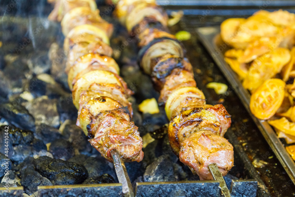 Meat kebabs cooking on skewers