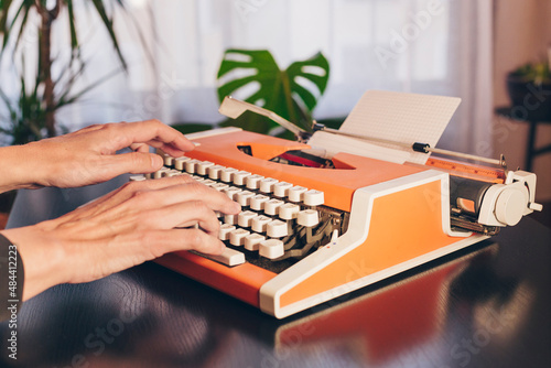 Writer's hands on retro typewriter. Concept classic literature