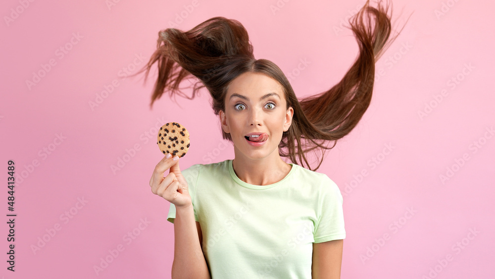Photo of surprised lady hold cookie enjoy confectionery lick tongue mouth isolated over pastel color background Photo of surprised lady hold cookie enjoy confectionery lick tongue mouth isolated over pastel color background