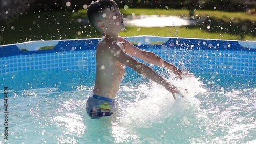 smiling boy is playing in swimming pool. Summer vacation or classes. Summertime and swimming activities for happy children on the pool.