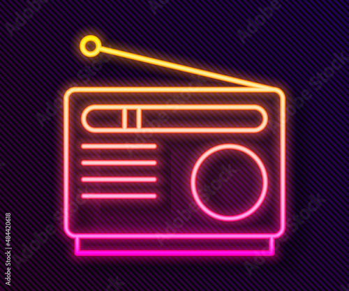Glowing neon line Radio with antenna icon isolated on black background. Vector