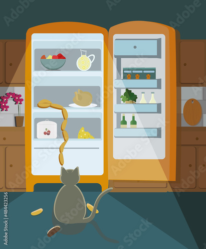 The cat sits in the dark by the open refrigerator and wants to steal a sausage.