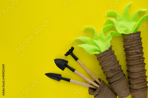 Composition of garden objects. Creative layout of  peat  gloves and tools. Flat lay.