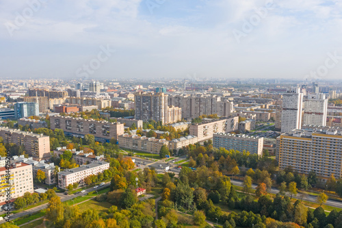 Autumn city park among apartment buildings from a height.