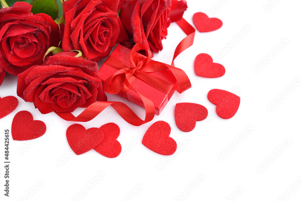 Red rose bouquet with gift box and red felt hearts on white background. Soft focus. Greeting card. Copy space for text Red rose bouquet with gift box and red felt hearts on white background. Soft focus. Greeting card. Copy space for text