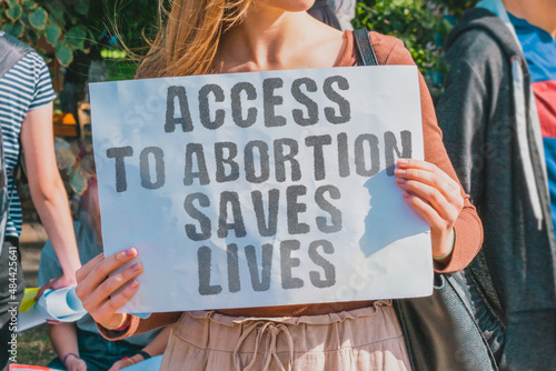 The phrase  Access to abortion saves lives  drawn on a paper in woman hands Fototapet