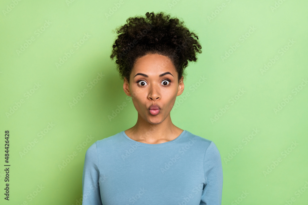 Photo of impressed adorable woman wear blue shirt lips pouted big eyes isolated green color background Photo of impressed adorable woman wear blue shirt lips pouted big eyes isolated green color background